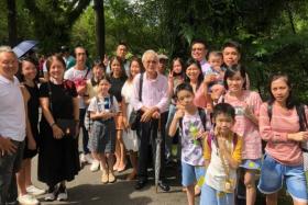 Army trainer Mr Lin Guo Rong (back row, right) with his family and friends waiting in line on May 7, 2022.