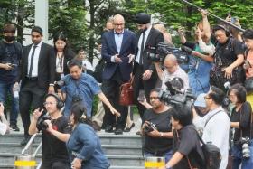 Former transport minister S. Iswaran, surrounded by the press, leaving the State Court on Jan 18.