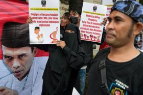 Muslim preacher Abdul Somad's supporters hold a protest in front of the Singapore embassy in Jakarta on May 20, 2022.