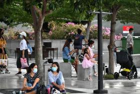 People wearing masks and relaxing at the Merlion Park on Aug 8, 2021. 