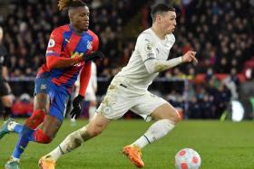 Manchester City&#039;s Phil Foden (right) in action against Crystal Palace&#039;s Wilfried Zaha (left), in London, on March 14, 2022.