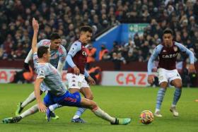 Manchester United&#039;s Nemanja Matic (left) slides in to tackle Aston Villa&#039;s Philippe Coutinho (centre), on Jan 15, 2022.